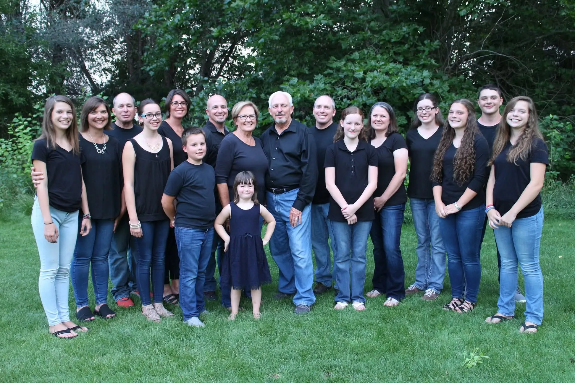 The founders of Garden Ministries with their family, standing together on a lawn in front of trees